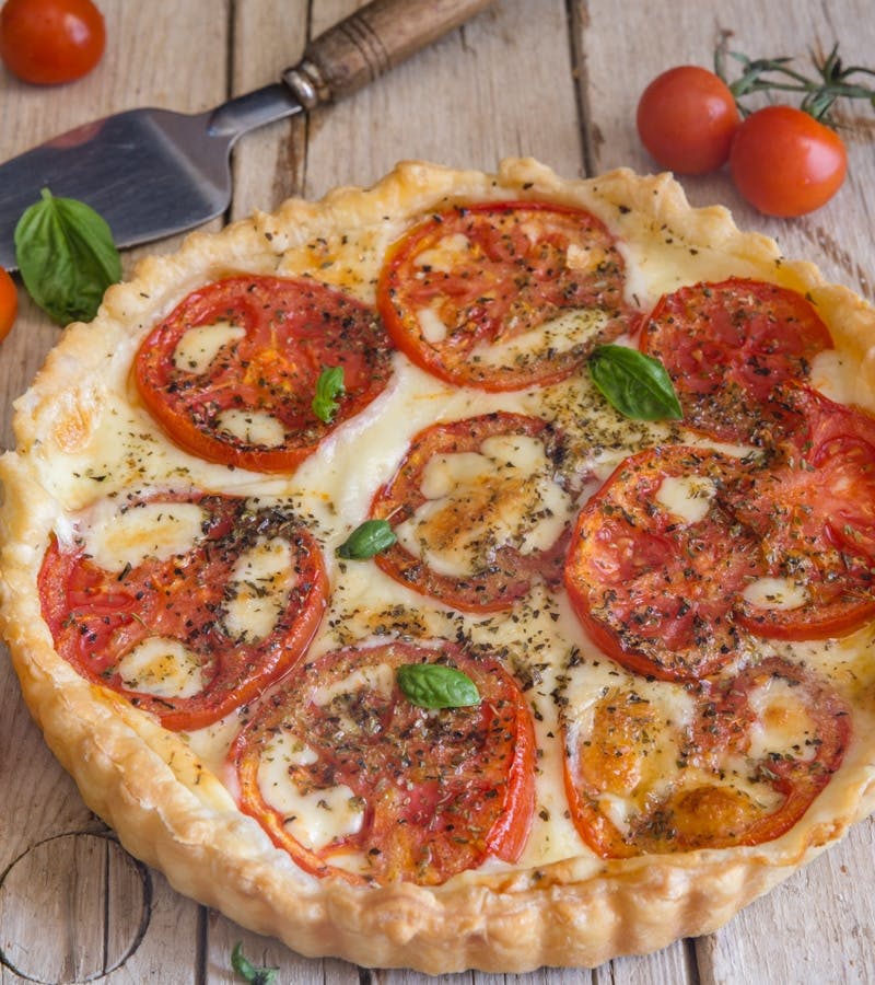 Tomato pie on a wooden board.