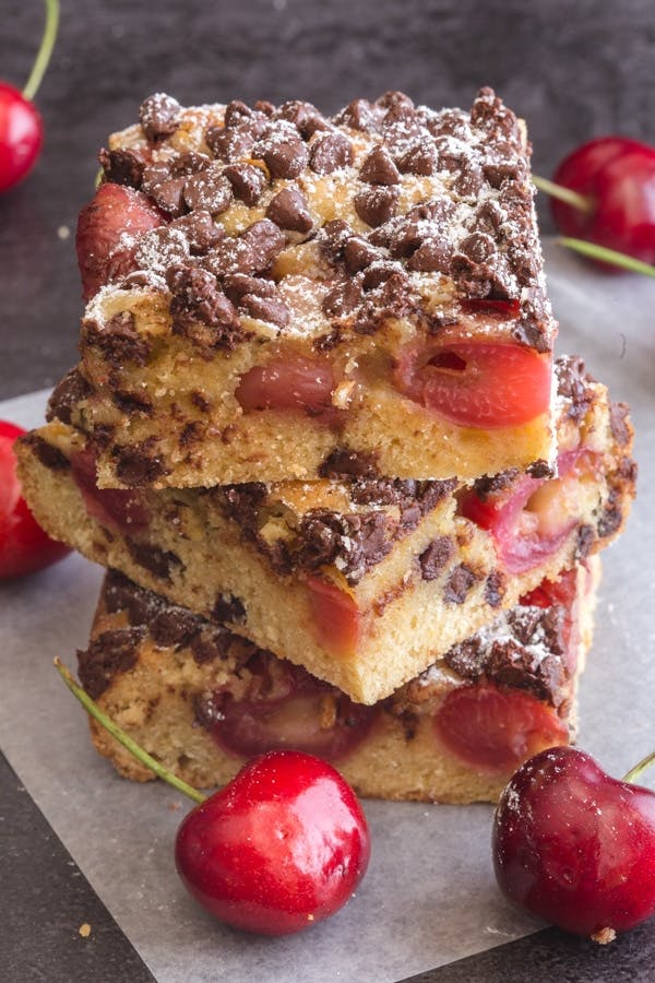 3 chocolate chip cherry blondies stacked.