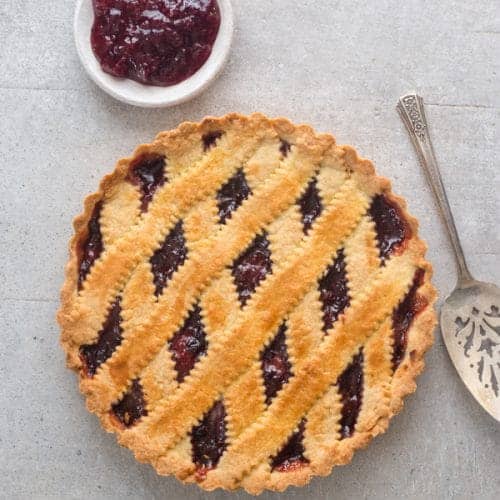 Classic Italian crostata on a grey board.