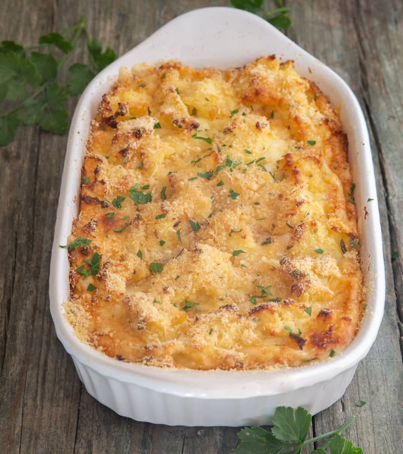 Mashed potato casserole in a white baking dish.