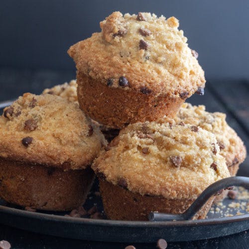 Muffins on a black tray.