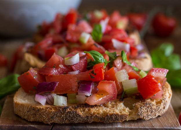 Tomato bruschetta on wooden board.