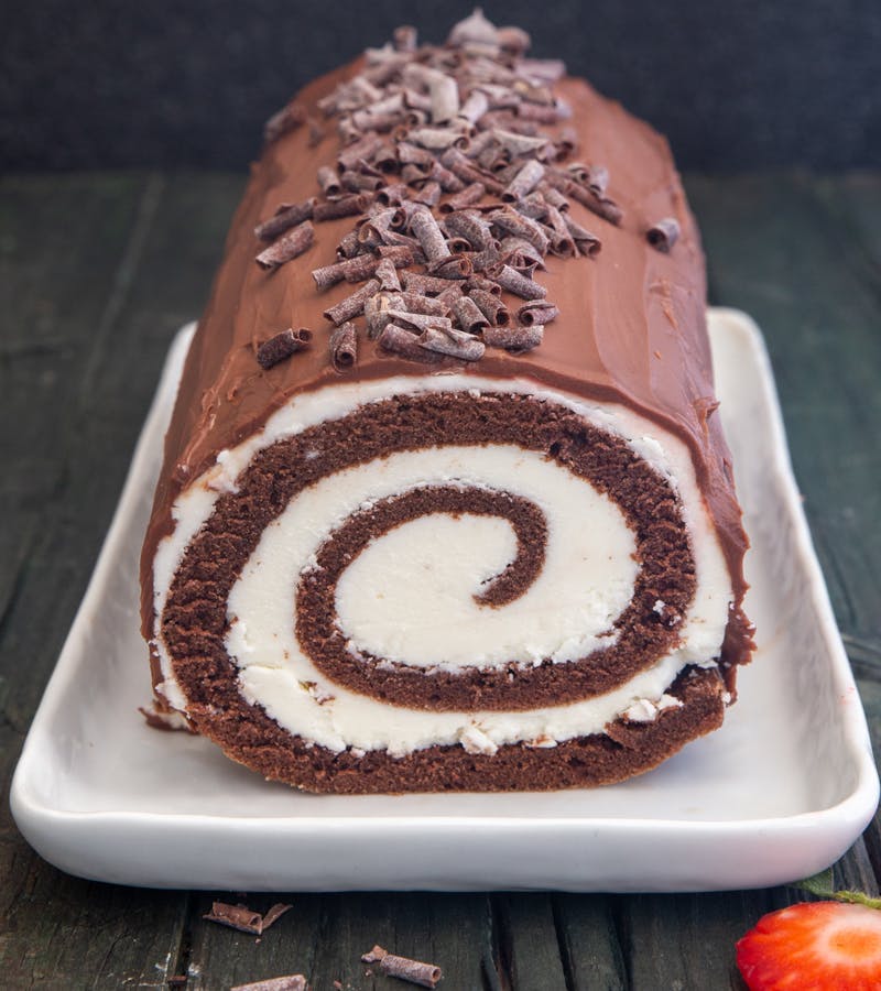 Swiss roll cake on a white dish.