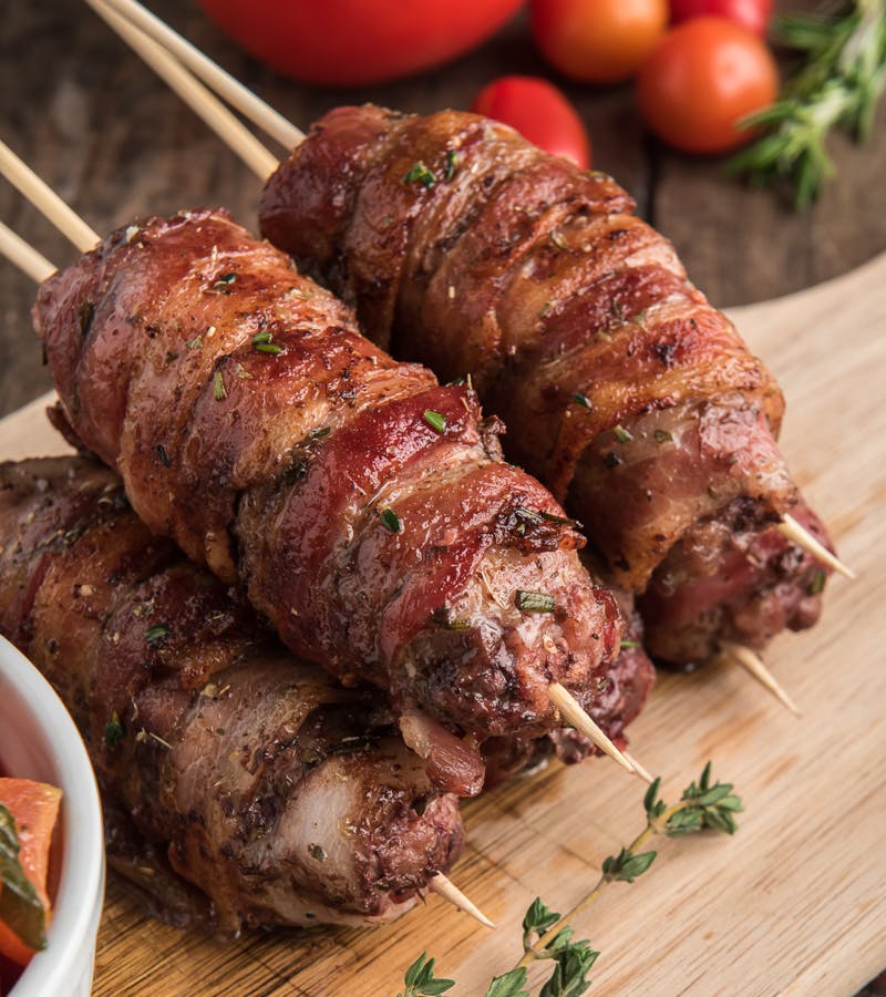 Beef skewers on a board.