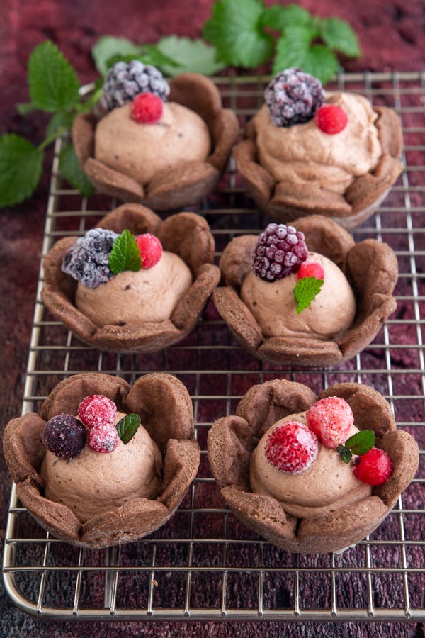 chocolate mousse tarts on a wire rack.