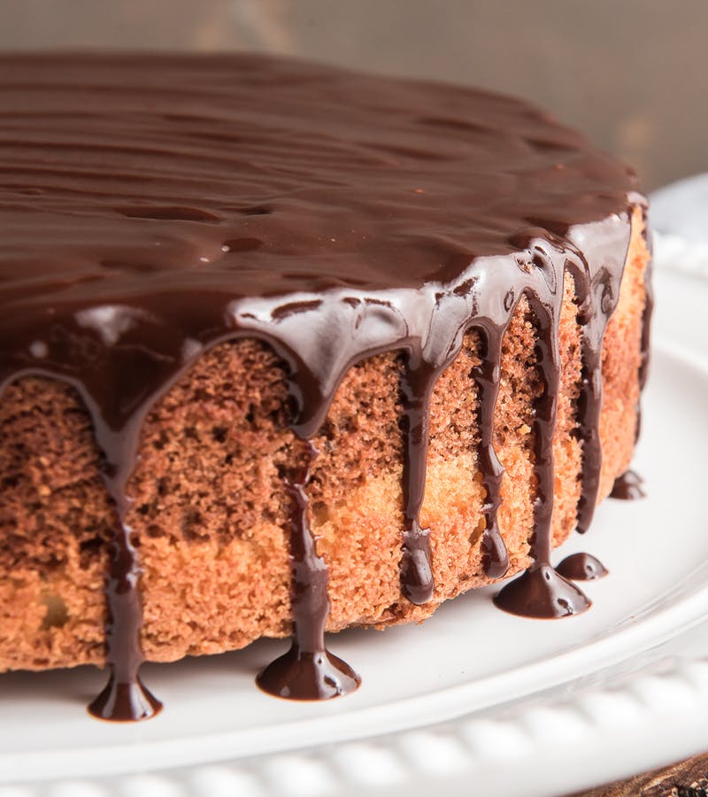 chocolate glazed marble cake on a white plate.