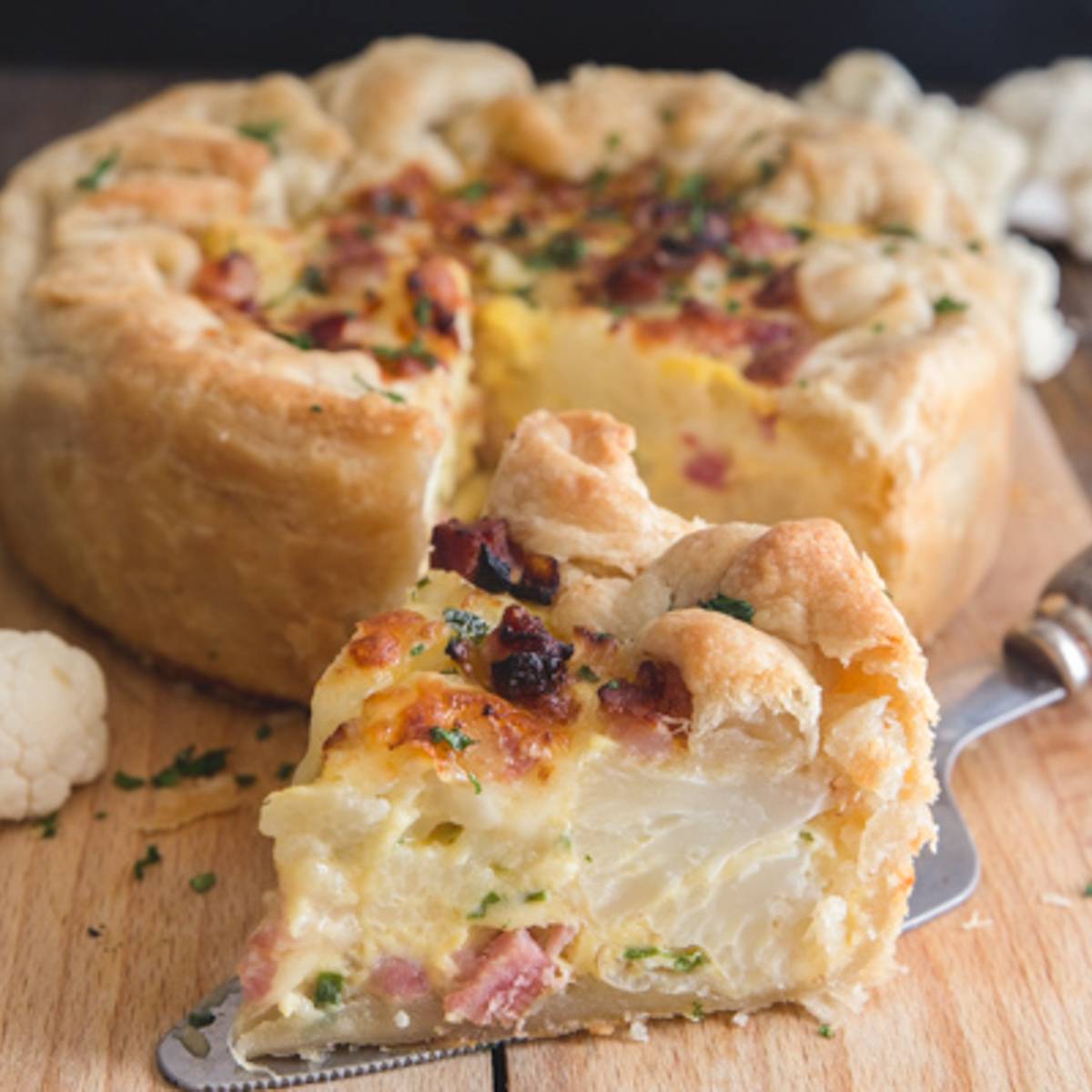 Cauliflower cheese pie with a slice cut.