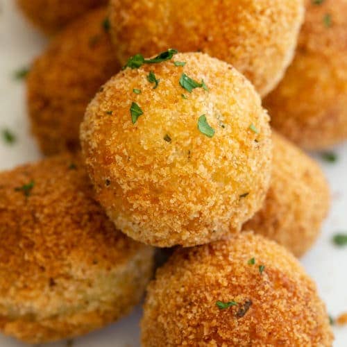 Mozzarella cheese balls on a board.