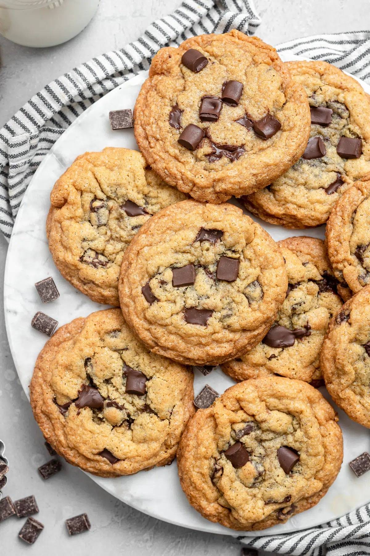 Chocolate chunk cookies on a white plate.