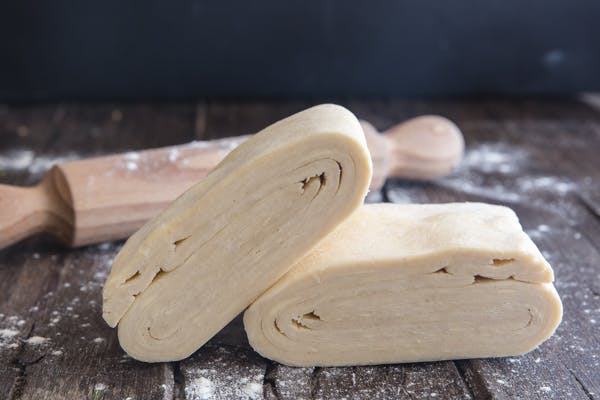 Puff pastry stacks on a black board.