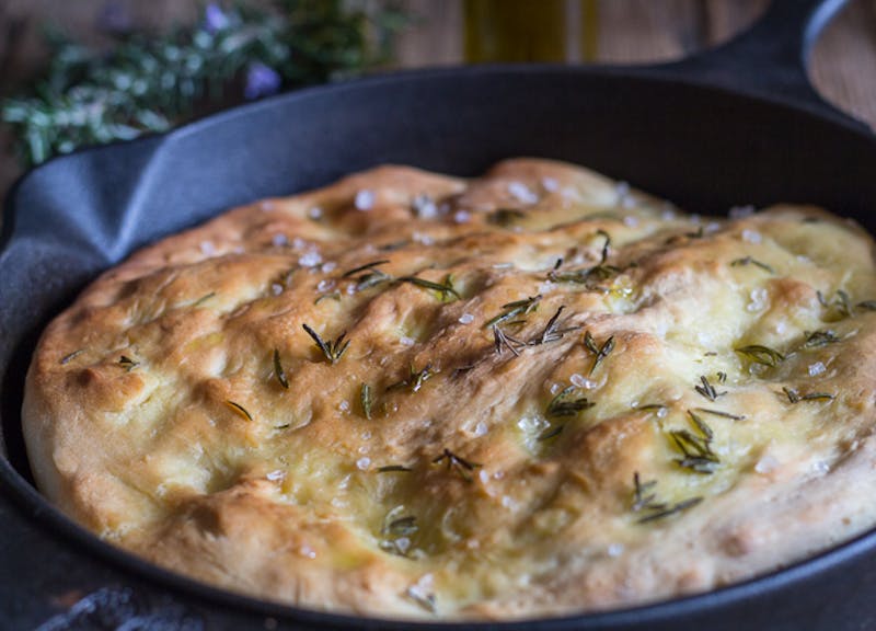 focaccia in a black pan.