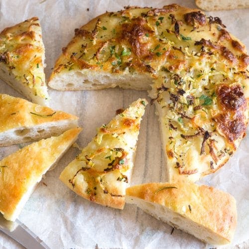 Focaccia on 2 black pans.