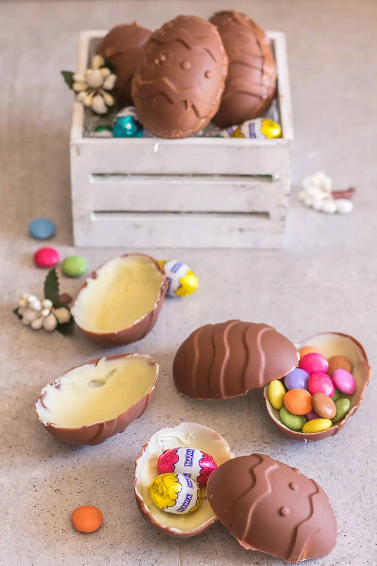 Homemade Easter eggs in a white box and three on the board.