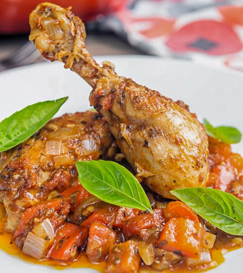 Chicken cacciatore on a white plate.