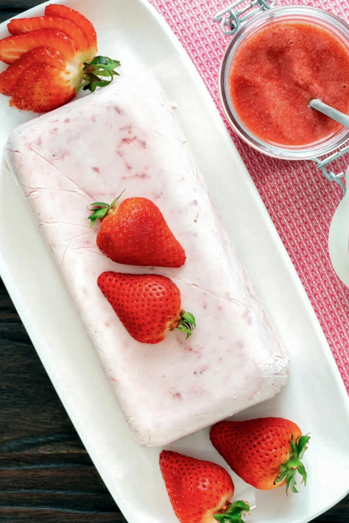 Strawberry semifreddo on a white plate.