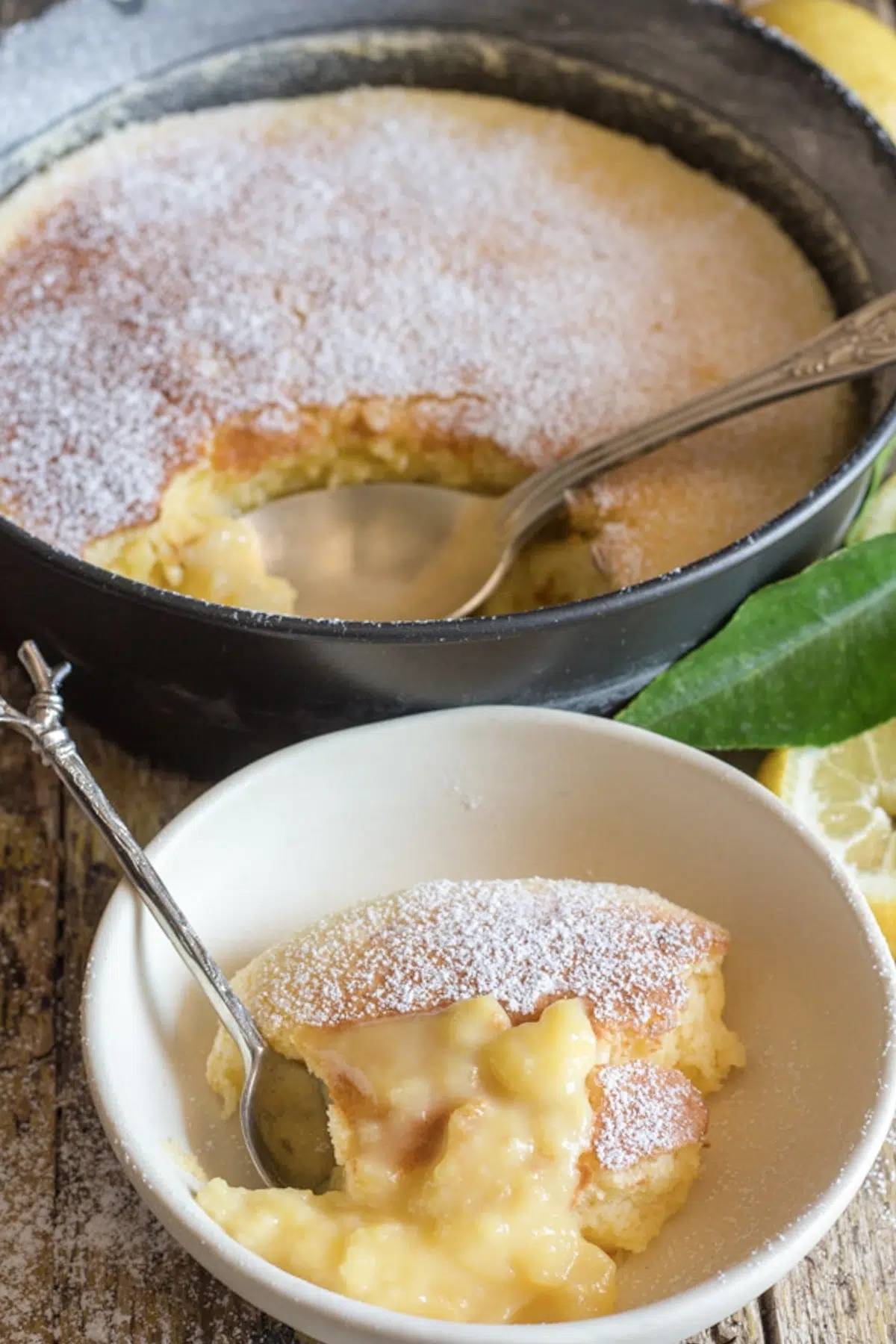 Lemon pudding cake in the pan and some in a bowl.