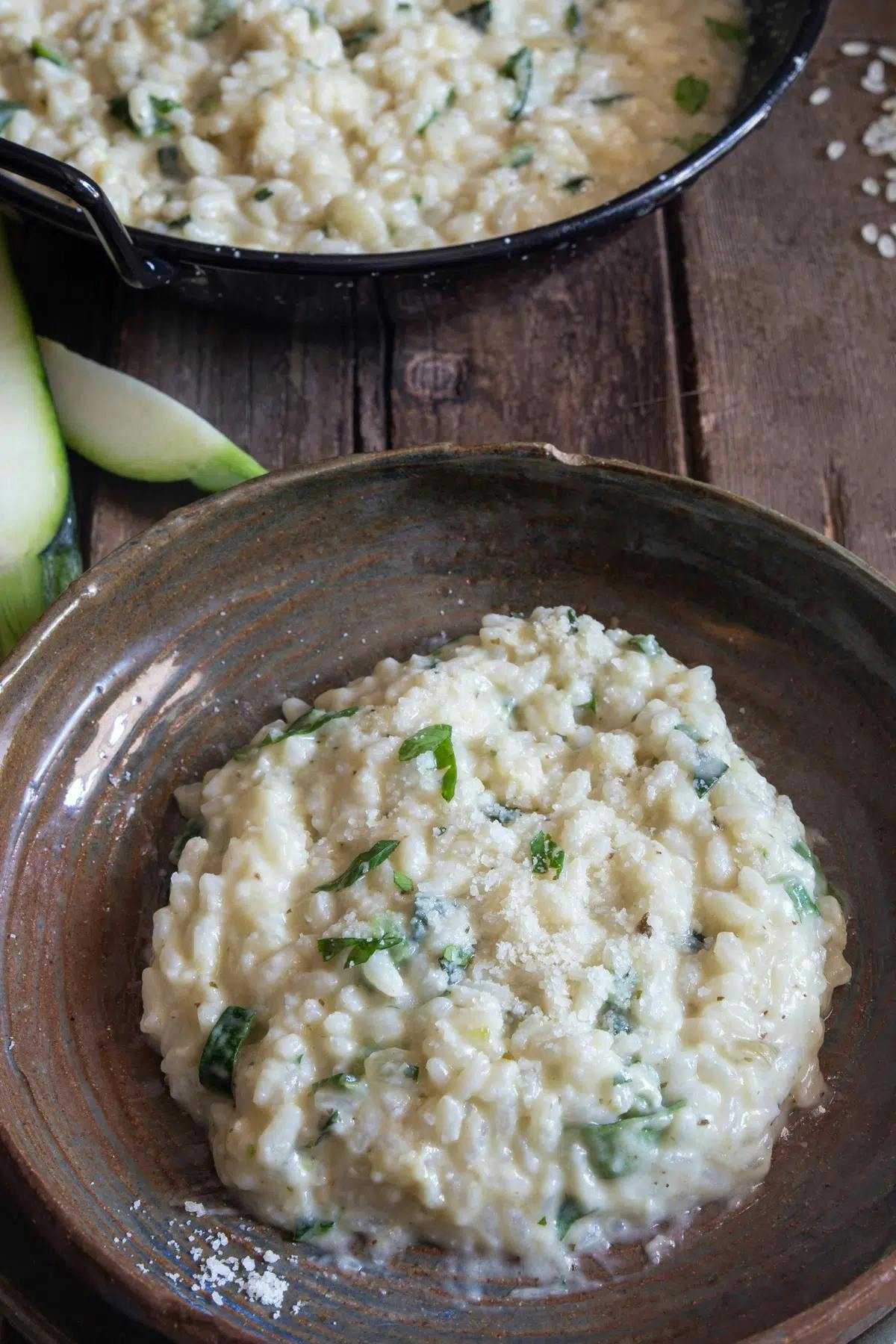 Zucchini risotto in a pan and on a plate.