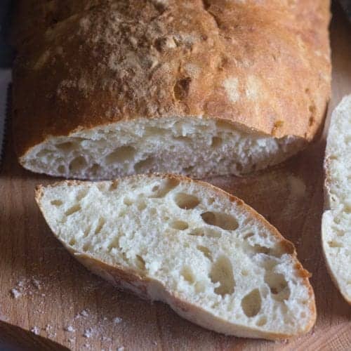 No Knead ciabatta bread with 2 slices cut.