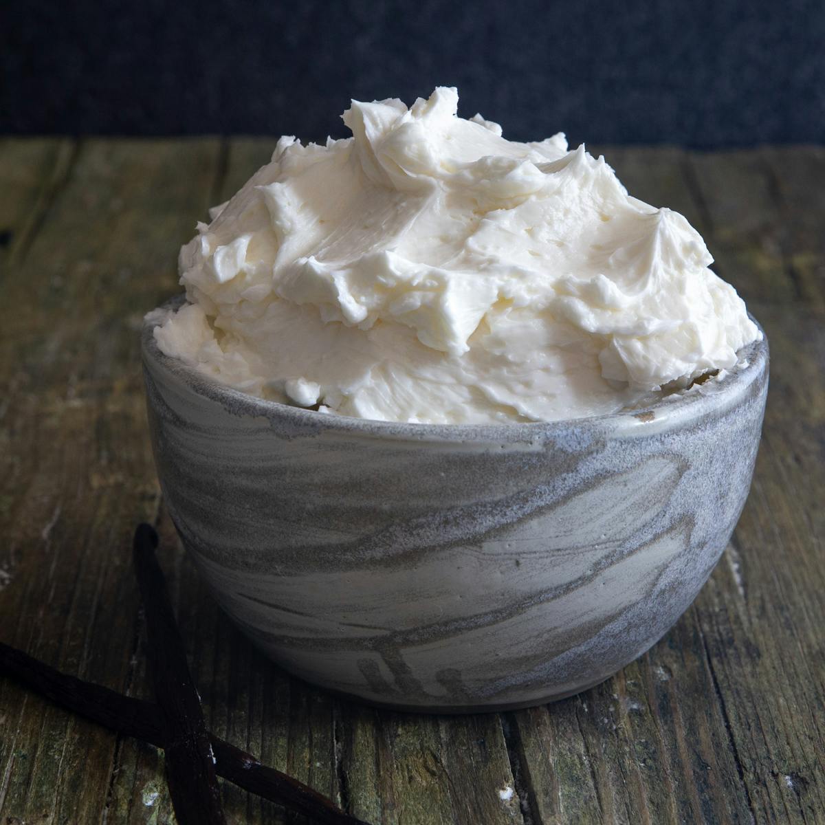 Swiss meringue buttercream in a sliver bowl.