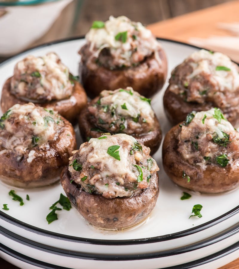 Italian stuffed mushrooms on a white plate.