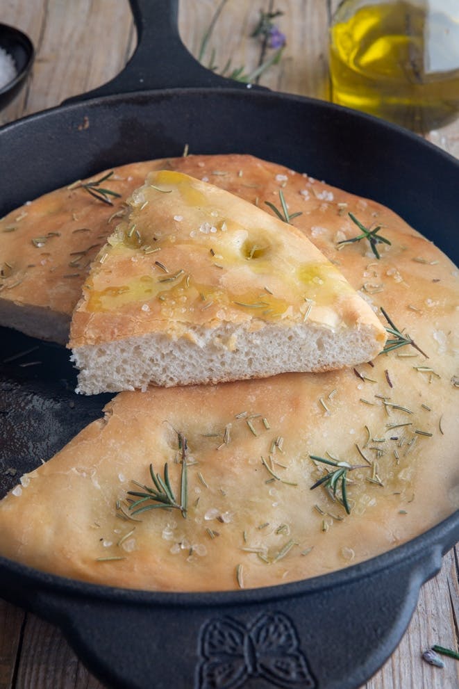 Sourdough focaccia with a slice cut.