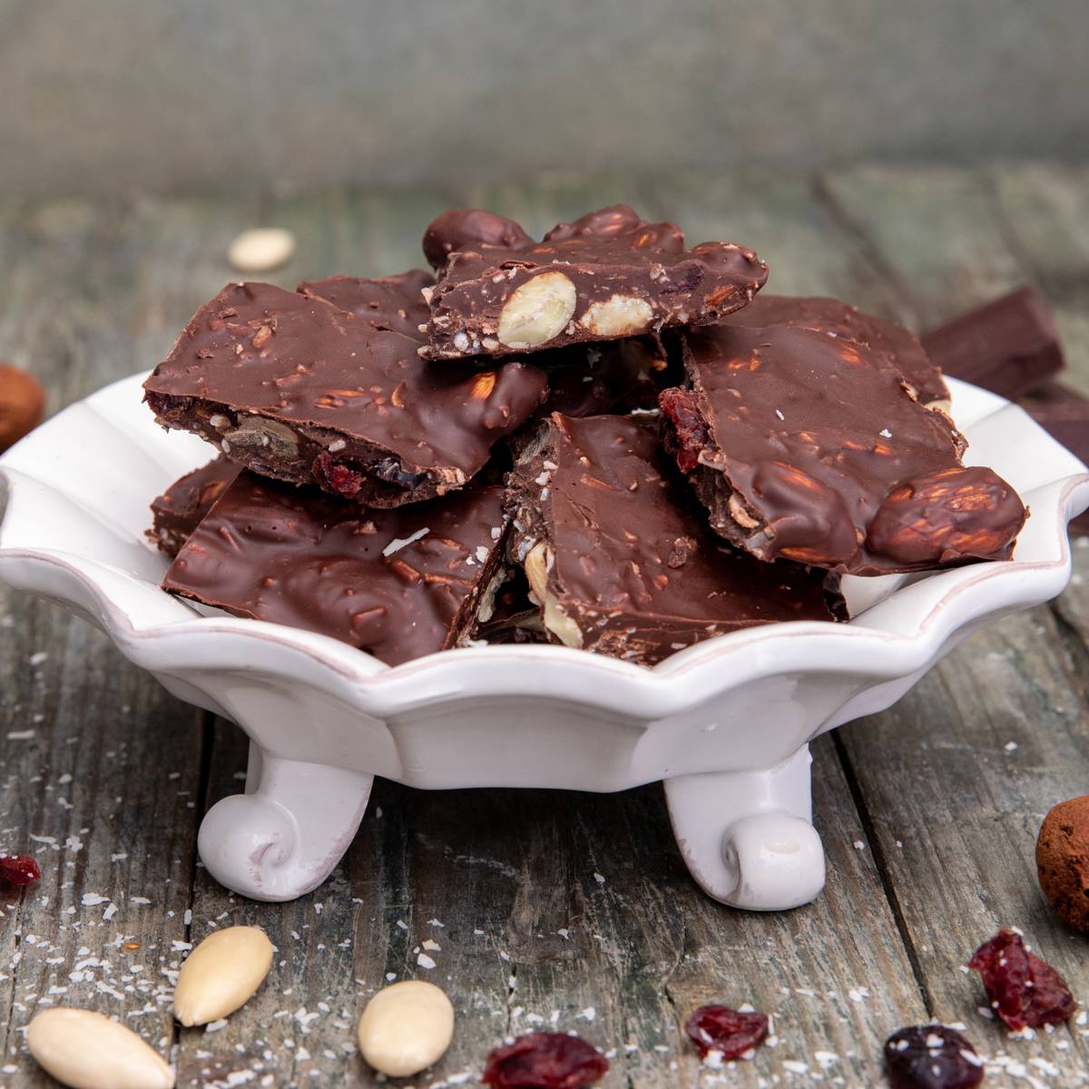 Almond bark pieces on a white plate.
