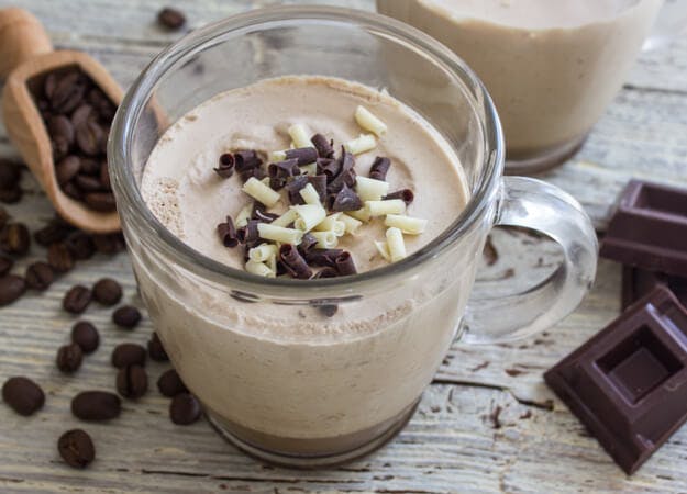 Baileys iced coffee in a glass mug.