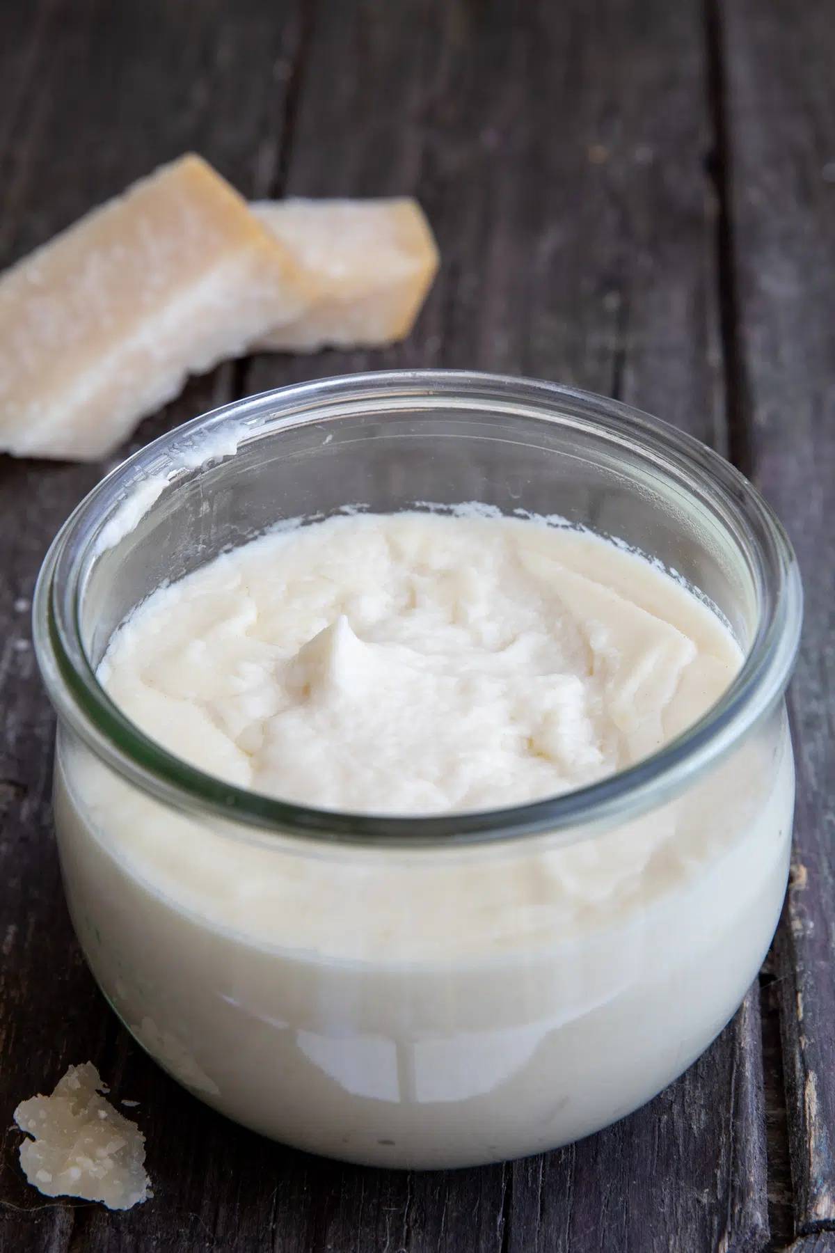 Parmesan cream sauce in a glass jar.