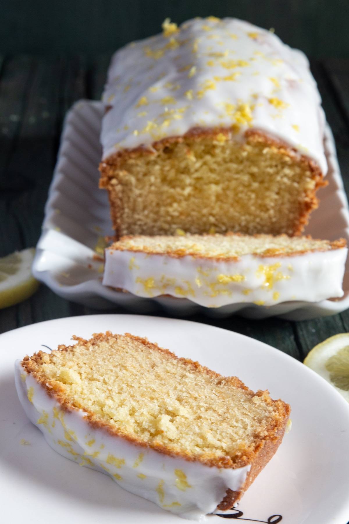 Lemon pound cake with a slice on a white plate.