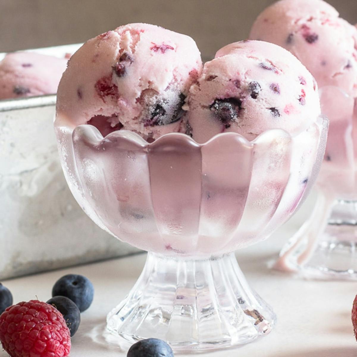 3 scoops of frozen yogurt in a glass dish.