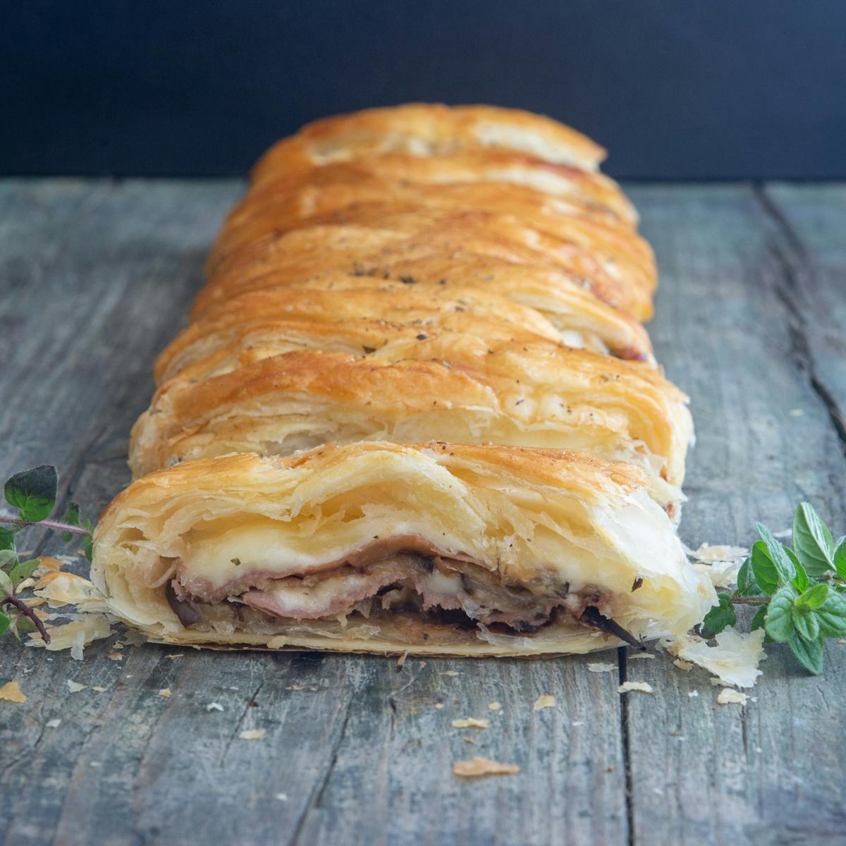 Eggplant strudel on a blue board.