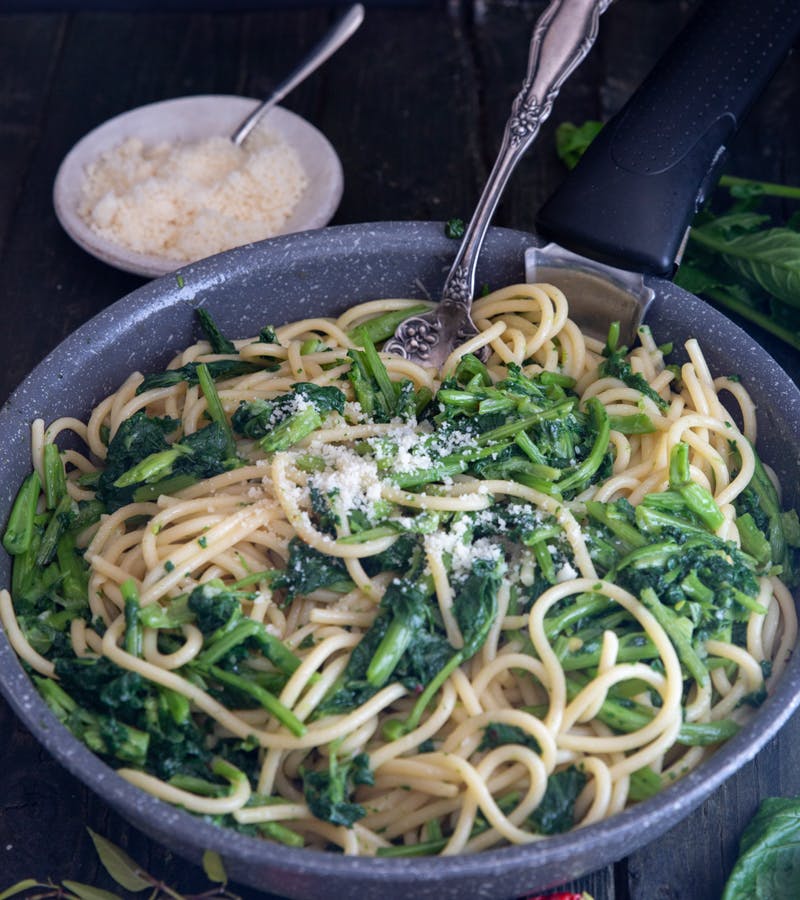 Pasta with broccoli rabe in a grey pan.