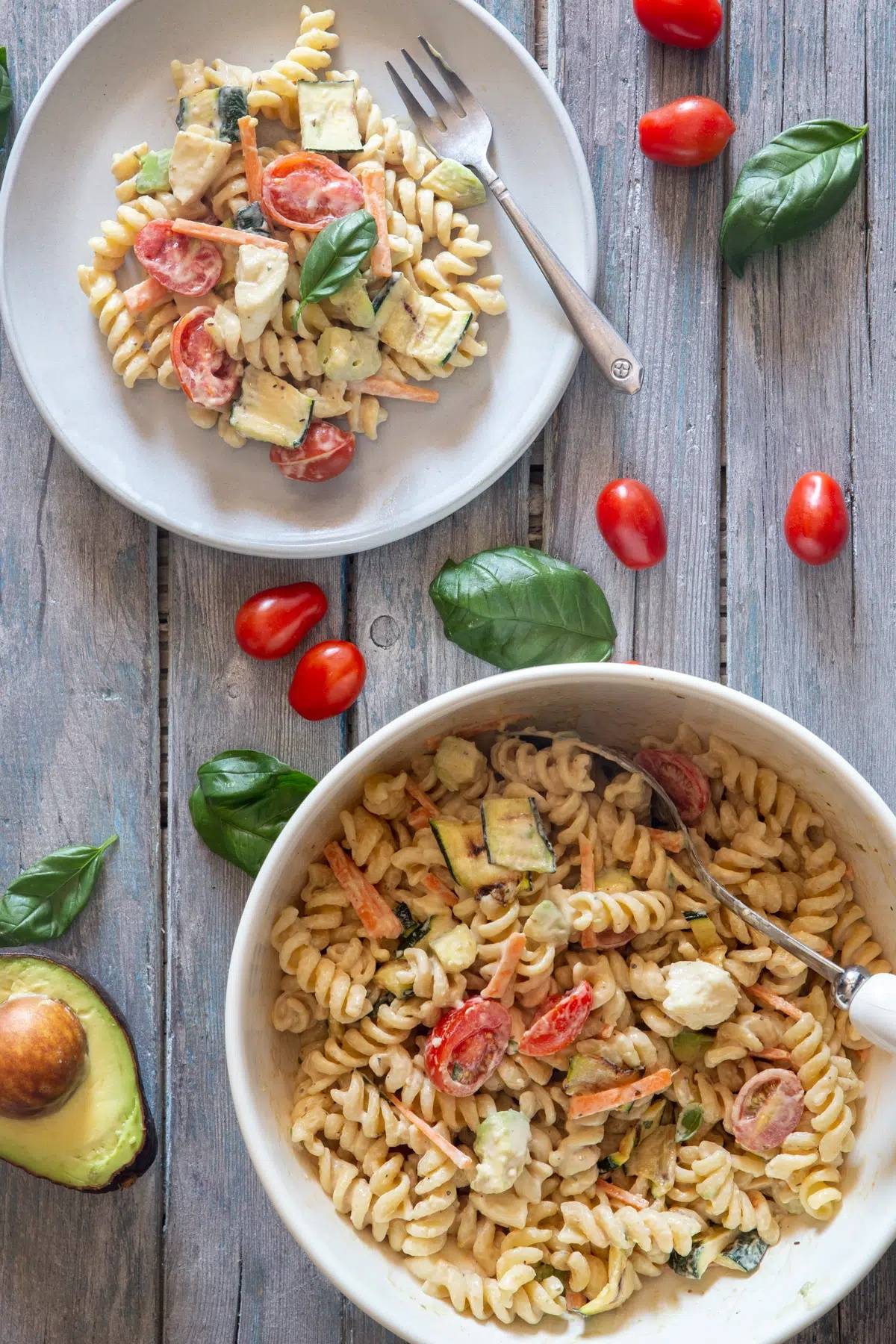 Italian pasta salad in a bowl and some on a plate.