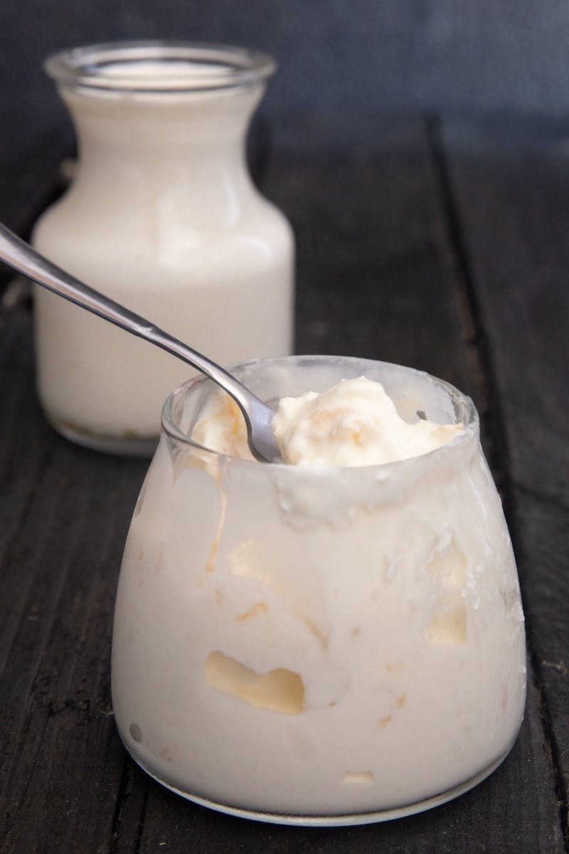 Homemade clotted cream in a small glass jar.