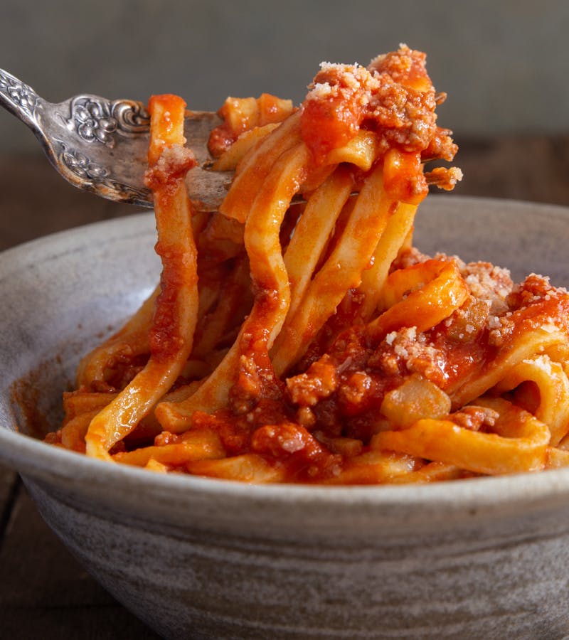 Bolognese sauce with pasta on a fork.