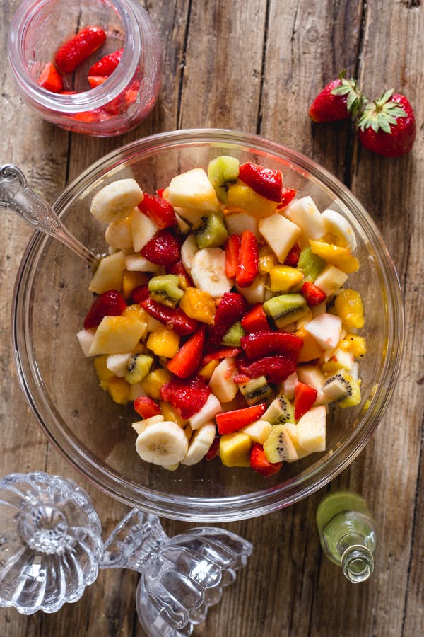 Italian fresh fruit salad in a glass bowl.