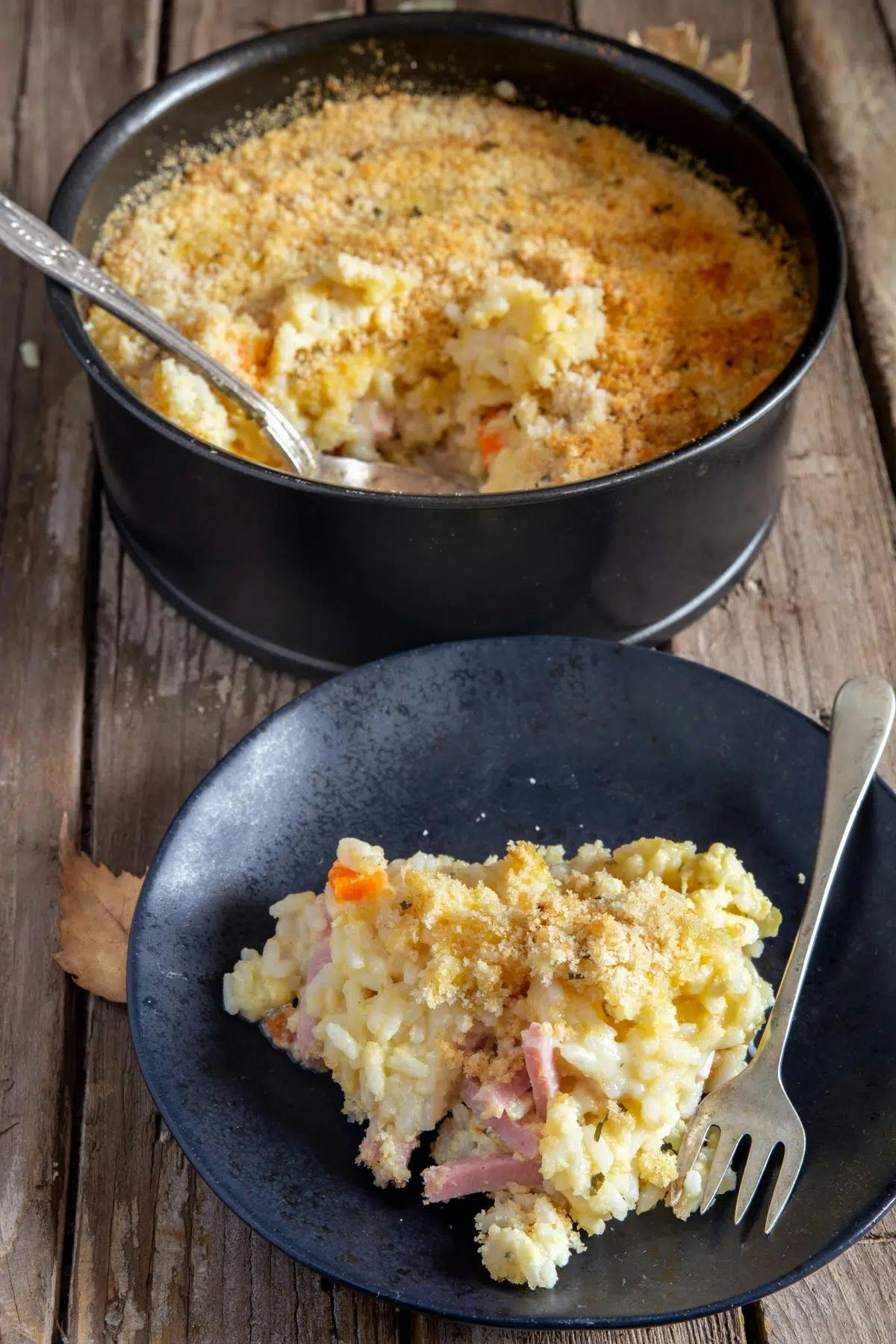 Rice casserole in a pan and on a black plate.