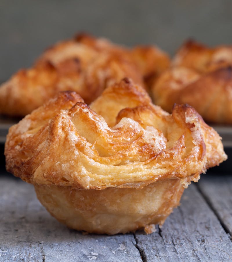 Kouign amann on a blue board.