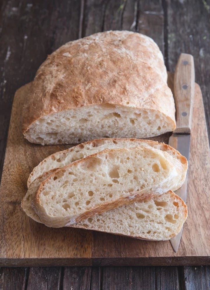 No knead bread with 3 slices cut.