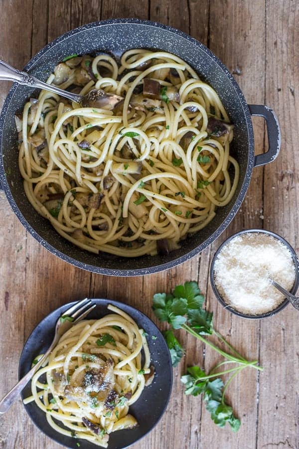 Simple bucatini pasta in a black pan and in a black dish.