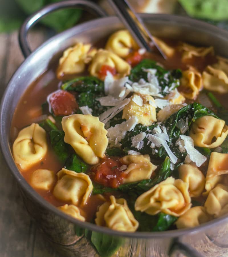 Hearty Tortellini soup in a pot.