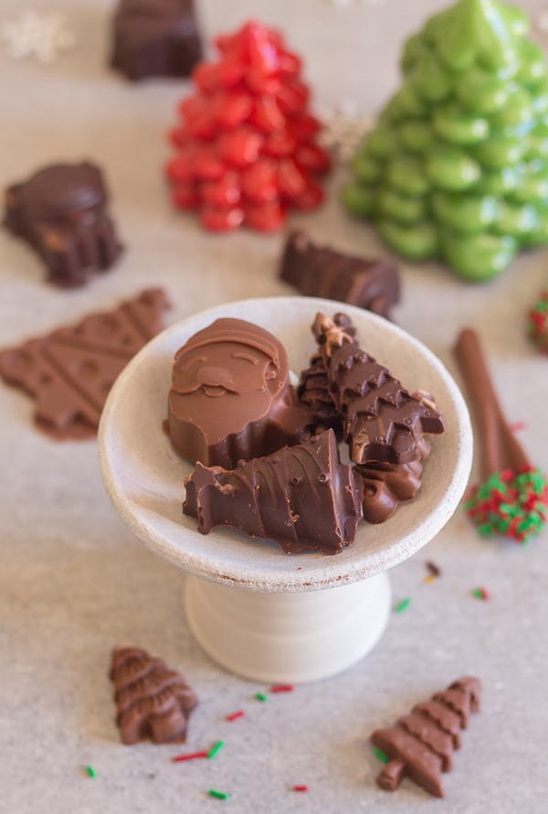 Homemade filled chocolates on a white plate.