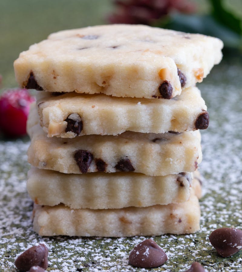 Chocolate almond shortbread cookies stacked.