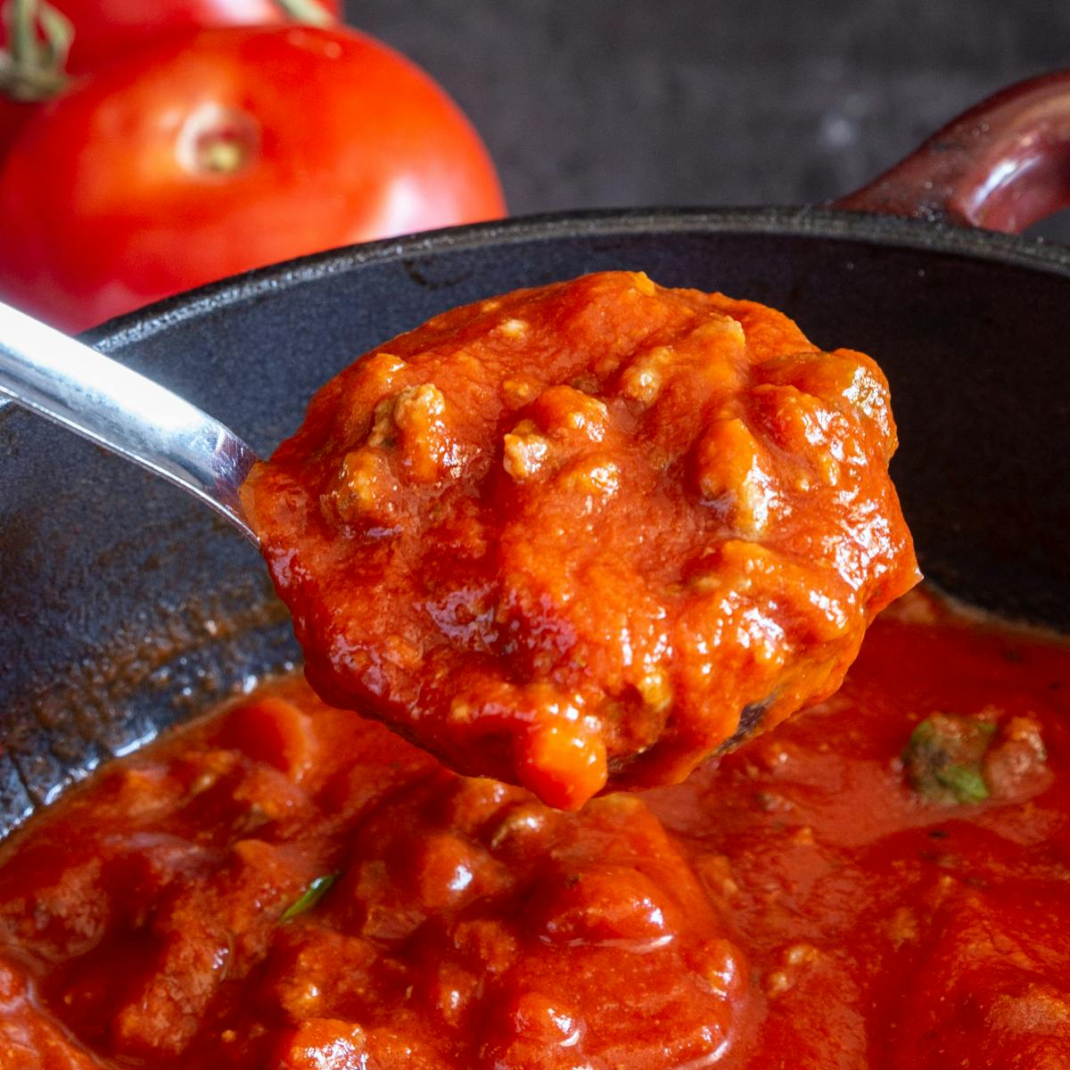 Meat sauce in a ladle.