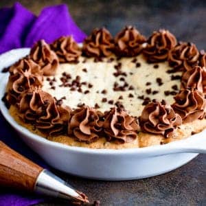 Chocolate chip cookie pie in a white pie plate.