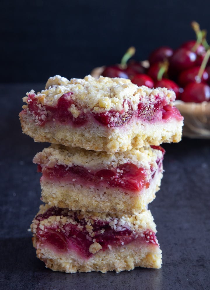 3 cherry crumb bars stacked.