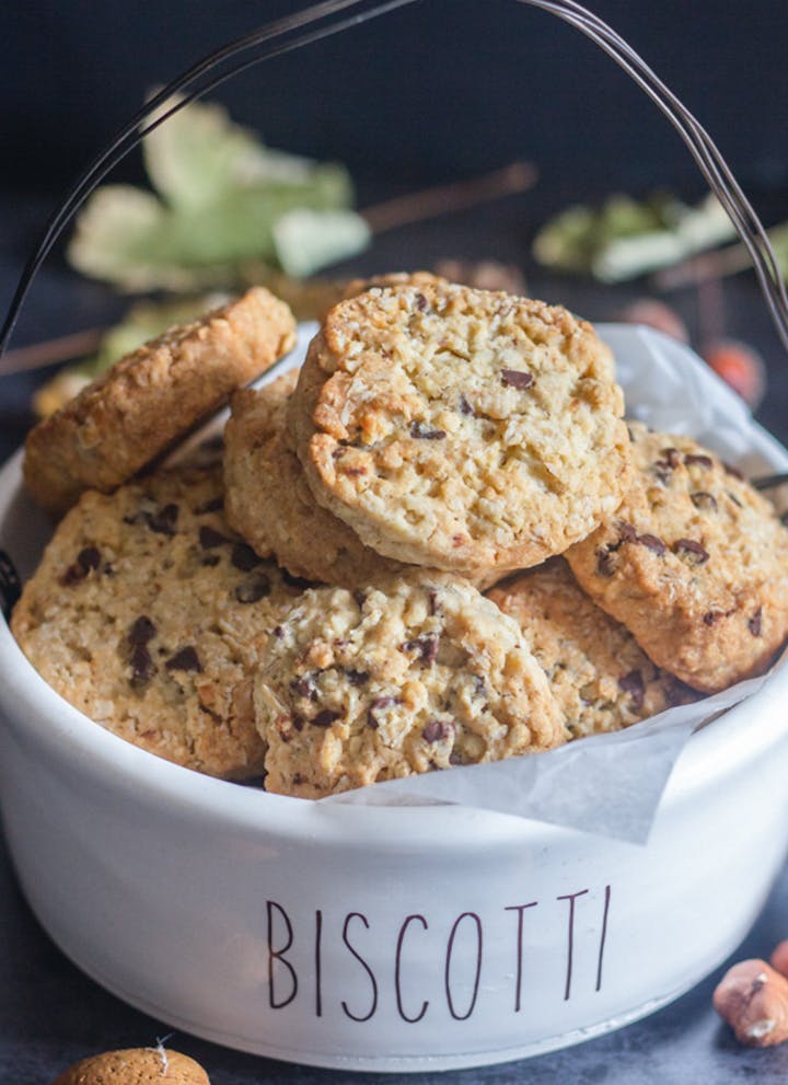 Oatmeal cookies in a white bowl.