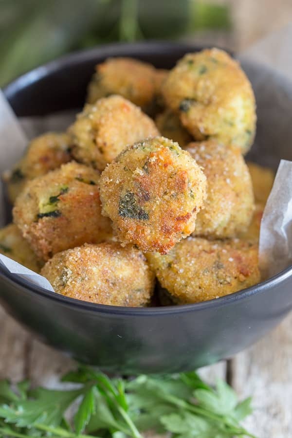 Cheesy zucchini bites in a bowl.