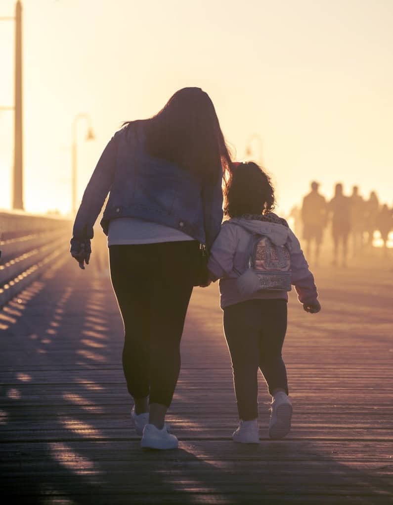 2 women walking on the road during daytime