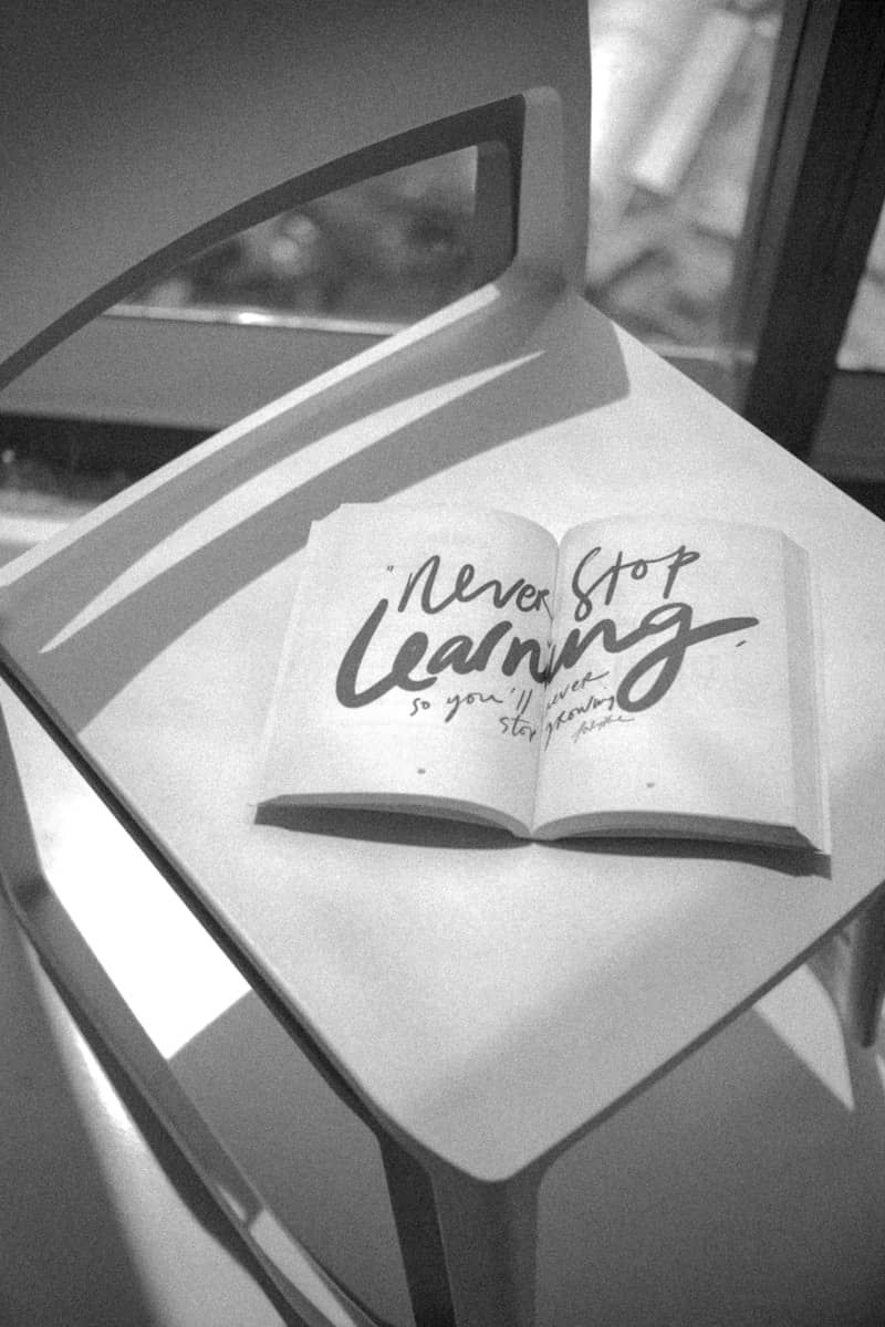 Open book with "never stop learning" quote on chair